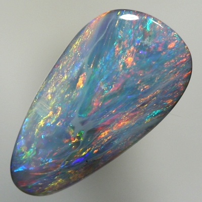 SOLID SEMI BLACK OPAL Red and orange sparkle over a green blue background